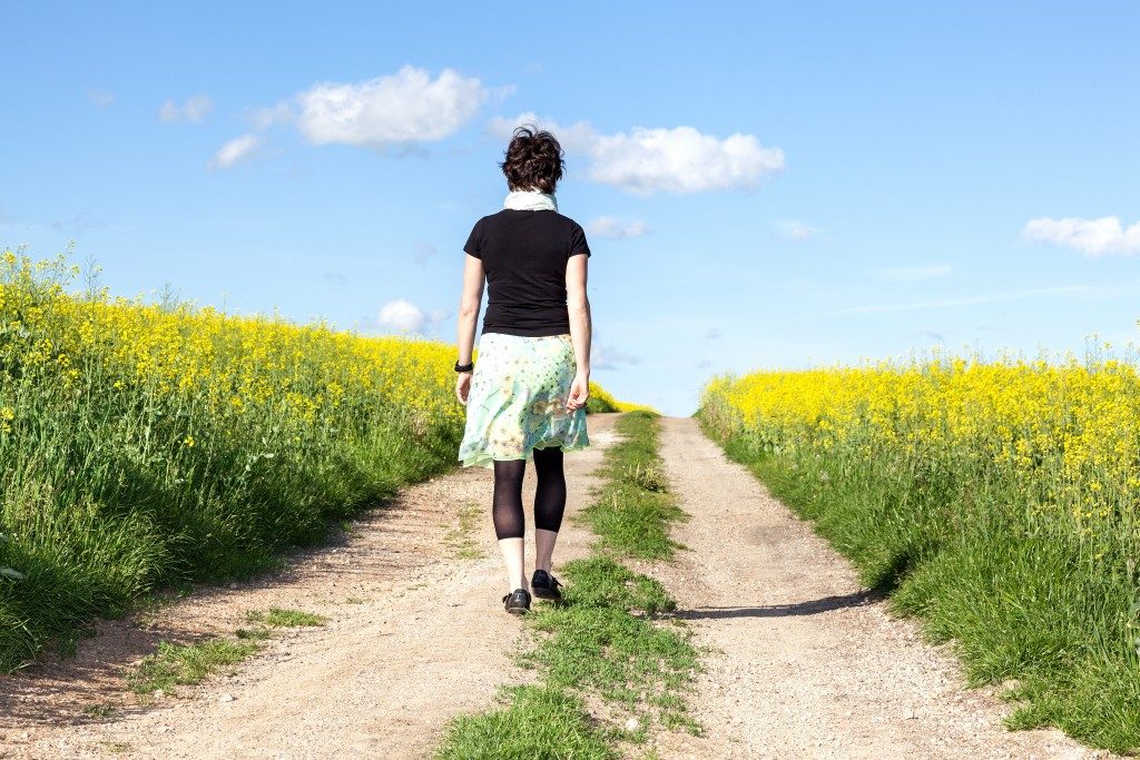 Single woman walking at the farm