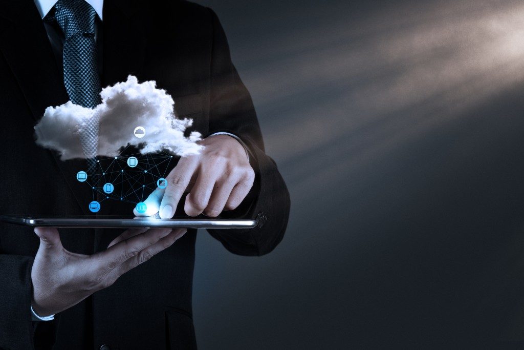 man touching tablet cloud concept